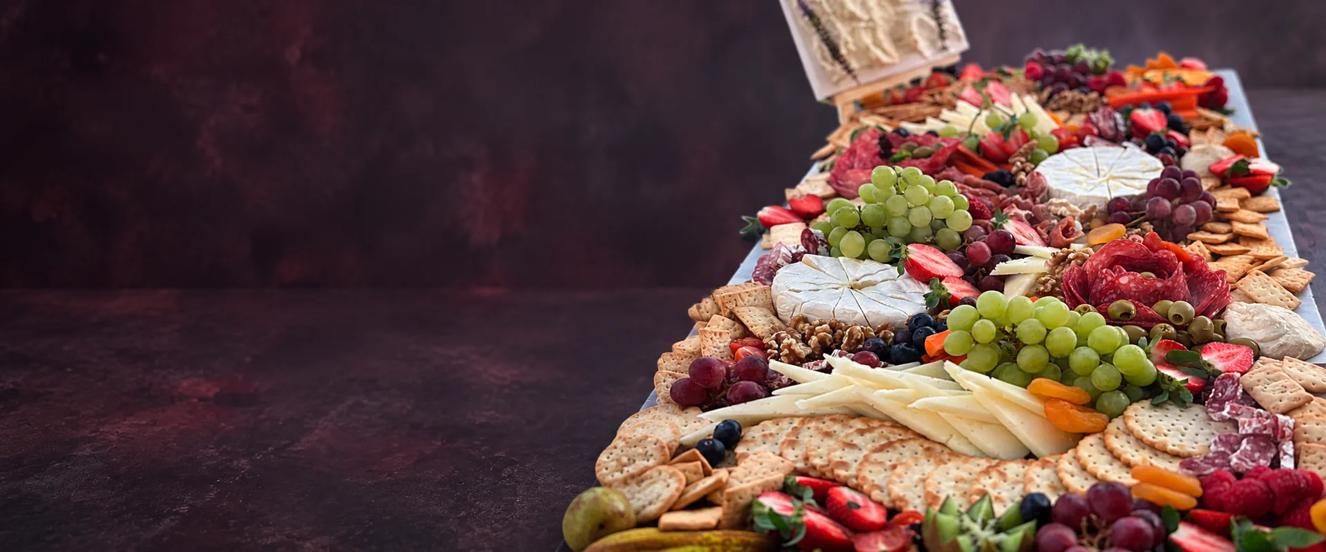 Large Elevate Catering grazing table with cheeses, fruit and charcuterie